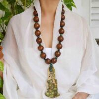 Model wearing Rare Hongshan Culture Hand Carved Antique Vintage Old Jade Pendant with Carved Wooden Tibetan Buddhist Prayer Meditation beads and moss green malachite beads