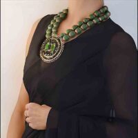 Model wearing Handcrafted Glass Afghani pendant necklace with Tibetan capped beads