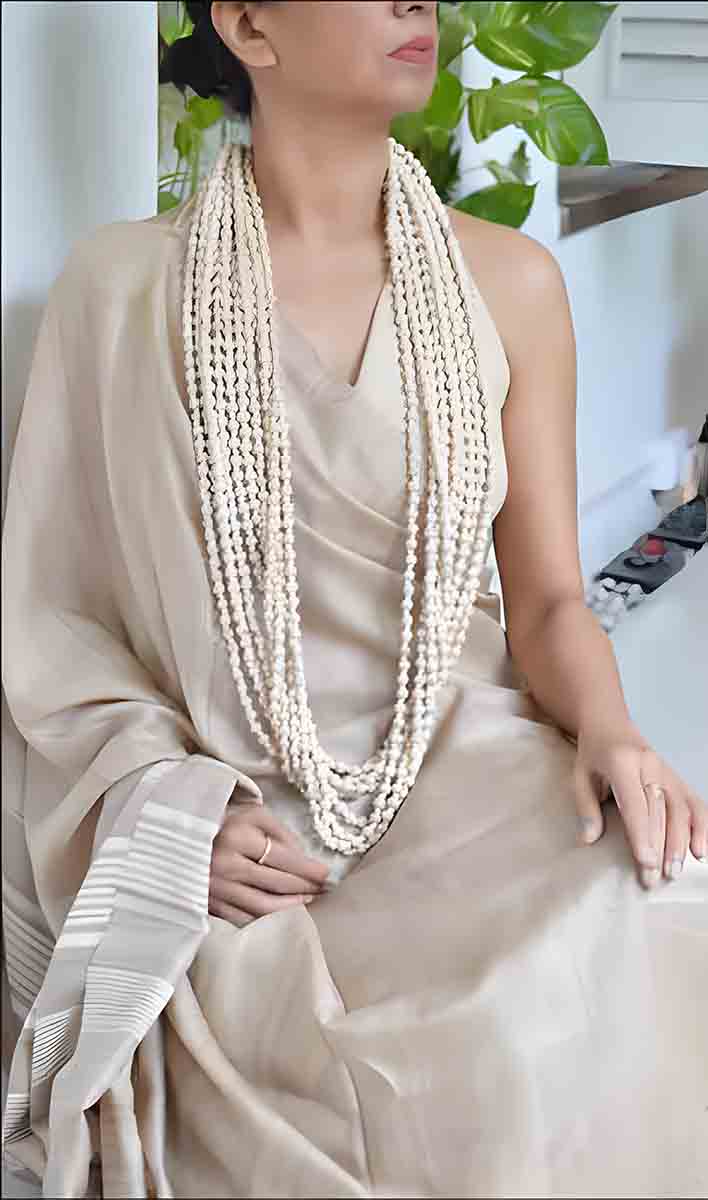 a model wearing a long Tulsi beads neclace a new trend in fashion jewellery