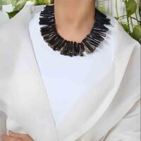 model wearing Black bamboo coral necklace with Naga brass bugles