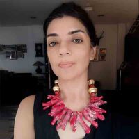 model wearing Chunky large raw coral branch sticks necklace with Nepali gold beads